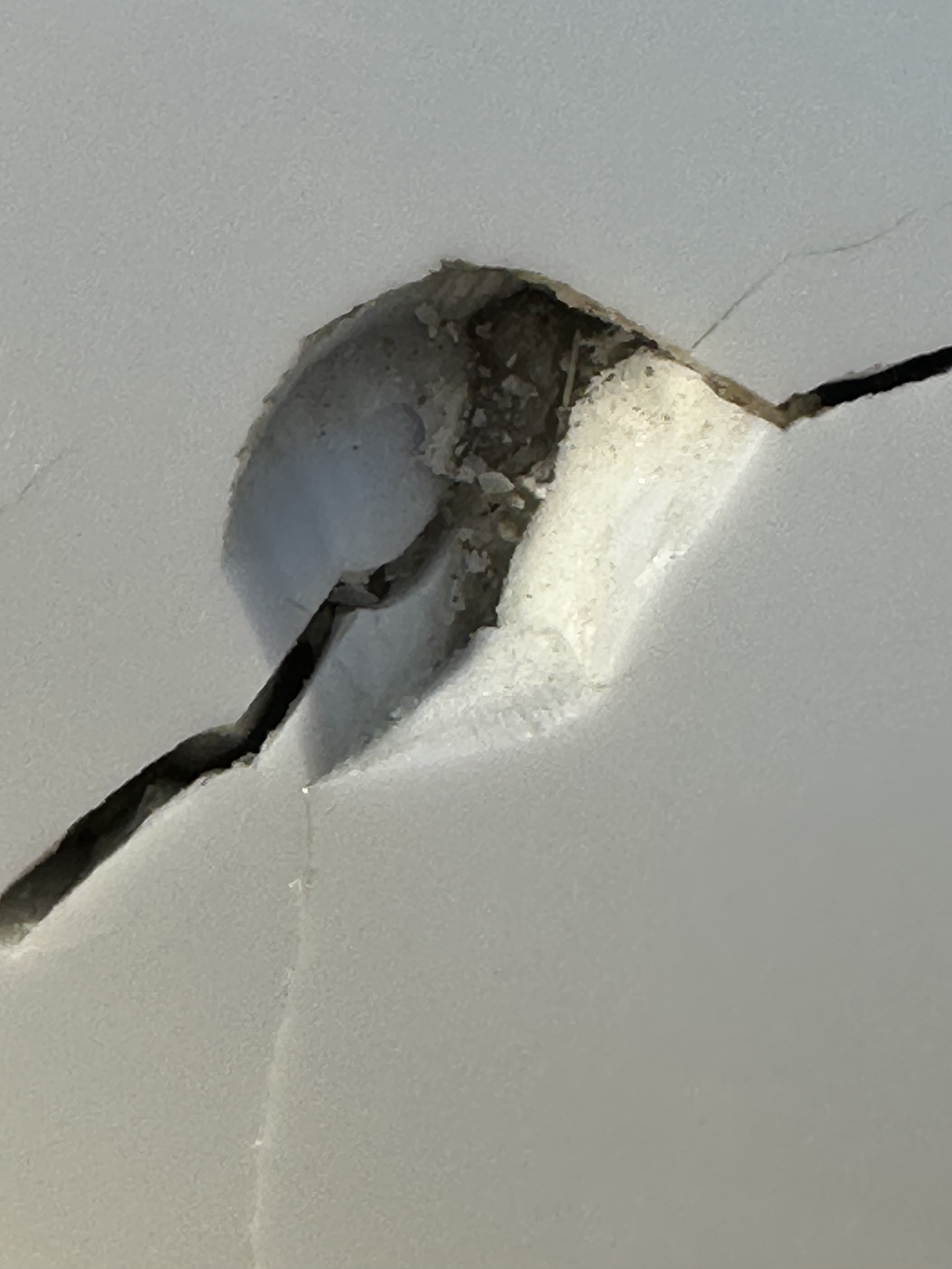 Close-up of shell chip — material ejected outward, not compressed inward