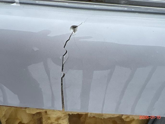 Close-up of crack showing width variation — widest at bottom