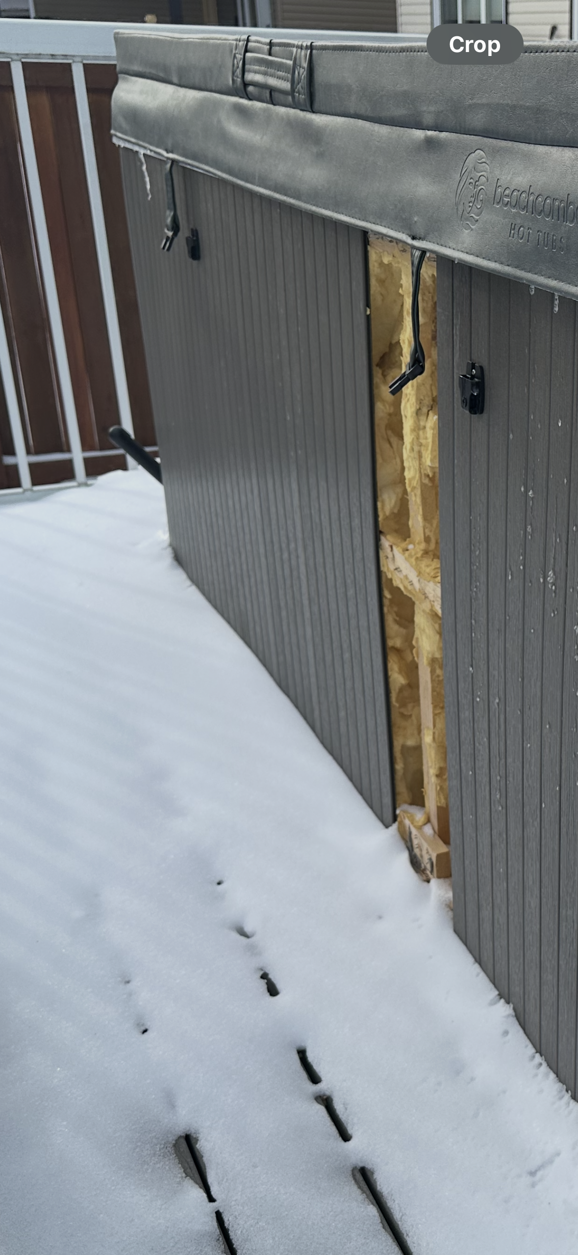 Beachcomber hot tub disassembled in Edmonton winter — skirting removed, insulation exposed