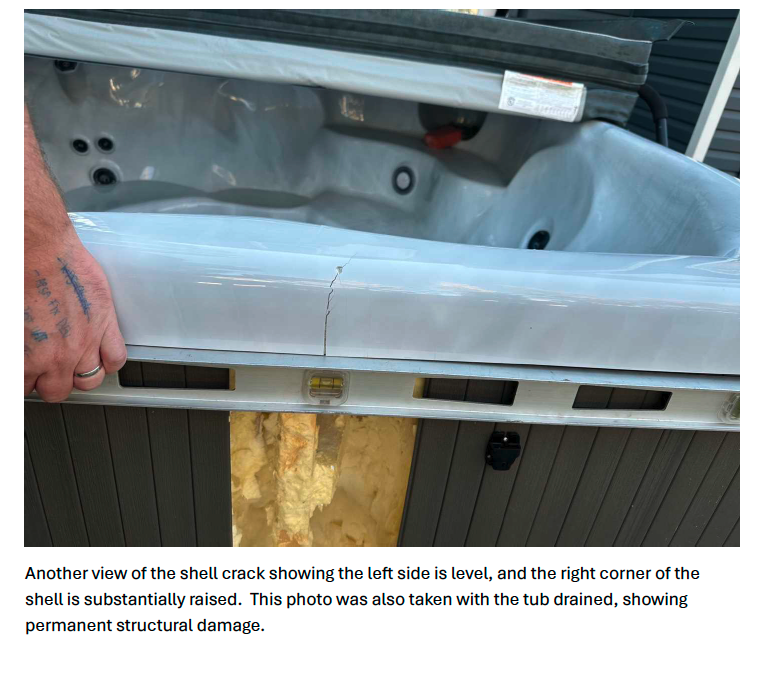 Spirit level showing right corner of shell substantially raised — permanent structural damage with tub drained